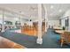 Large meeting room features a coffered ceiling with fans, a library, and multiple tables and chairs for community members at 1800 Mariner Dr # 9, Tarpon Springs, FL 34689