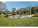 Scenic pond featuring a fountain, surrounded by mature trees and well-maintained grassy areas at 1800 Mariner Dr # 9, Tarpon Springs, FL 34689