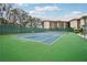 Well-maintained tennis court within the community, featuring an adjacent sitting area and lush landscaping for resident enjoyment at 1800 Mariner Dr # 9, Tarpon Springs, FL 34689