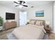 This primary bedroom features an oversized ceiling fan and a mounted television at 1884 Clearbrooke Dr # 1884, Clearwater, FL 33760