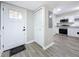 Bright foyer featuring durable floors, a closet, and a view of the beautifully renovated kitchen at 1884 Clearbrooke Dr # 1884, Clearwater, FL 33760