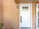 Close-up of the exterior front door with glass panels and a security system at 1884 Clearbrooke Dr # 1884, Clearwater, FL 33760