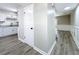 Hallway with new floors connecting the kitchen, living room, and stairs to the upper floors at 1884 Clearbrooke Dr # 1884, Clearwater, FL 33760