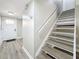 Hallway featuring a stairway to the upper floors, new floors, and access to the front door at 1884 Clearbrooke Dr # 1884, Clearwater, FL 33760