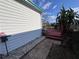 Exterior view of a home with a deck and tropical plants at 2331 Belleair Rd # 527, Clearwater, FL 33764
