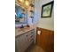 Cozy bathroom featuring a vanity with a tan countertop and paneled walls with stylish decor at 2331 Belleair Rd # 527, Clearwater, FL 33764