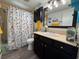 Charming bathroom with a vanity, decorative mirror, and shower-tub combination at 2331 Belleair Rd # 527, Clearwater, FL 33764