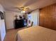 Bright bedroom with wood accents, dresser, and sliding glass doors to a screened porch at 2331 Belleair Rd # 527, Clearwater, FL 33764
