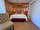 Comfortable bedroom with wood paneling and modern decor, featuring a cozy bed and closet at 2331 Belleair Rd # 527, Clearwater, FL 33764