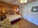 Cozy bedroom with wood paneling, featuring a bed, closet, and charming decor at 2331 Belleair Rd # 527, Clearwater, FL 33764
