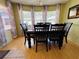 Comfortable dining room with a wood table, chairs, and large windows at 2331 Belleair Rd # 527, Clearwater, FL 33764