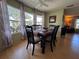 Cozy dining room featuring a wood table, six chairs, and large windows at 2331 Belleair Rd # 527, Clearwater, FL 33764