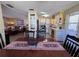 Cozy dining area leading into a functional kitchen with white cabinets and modern appliances at 2331 Belleair Rd # 527, Clearwater, FL 33764