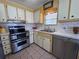 Functional kitchen featuring white cabinets and stainless steel appliances at 2331 Belleair Rd # 527, Clearwater, FL 33764