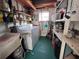 Laundry room with washer, dryer, shelves, and sink at 2331 Belleair Rd # 527, Clearwater, FL 33764