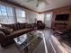 Bright living room featuring a large window, comfortable seating, and light wood-paneled walls at 2331 Belleair Rd # 527, Clearwater, FL 33764