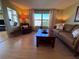 Relaxing living room featuring a sofa, armchair, and stylish decor at 2331 Belleair Rd # 527, Clearwater, FL 33764