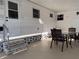 Covered patio with a table, chairs, and a door leading inside at 2331 Belleair Rd # 527, Clearwater, FL 33764