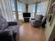 Bright sunroom with large windows, comfortable seating, and views of the outdoors at 2331 Belleair Rd # 527, Clearwater, FL 33764