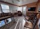Comfortable sunroom with wood paneling, a ceiling fan, and plenty of natural light at 2331 Belleair Rd # 527, Clearwater, FL 33764