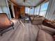 Relaxing sunroom with wood paneling, comfortable seating, and plenty of natural light at 2331 Belleair Rd # 527, Clearwater, FL 33764