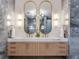 Luxurious bathroom with dual sinks, marble countertops, decorative mirrors, and modern lighting fixtures at 2912 W Santiago St # 1504, Tampa, FL 33629