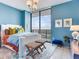 Bright bedroom featuring a city view, modern lighting, and decorative pillows on the bed at 2912 W Santiago St # 1504, Tampa, FL 33629