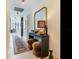 Bright hallway showcasing a console table, stylish ottomans, and decorative wall mirror at 2912 W Santiago St # 1504, Tampa, FL 33629