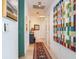 Inviting hallway featuring colorful artwork, chic furnishings, and neutral wall colors at 2912 W Santiago St # 1504, Tampa, FL 33629