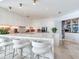 Bright kitchen featuring marble countertops, white cabinets, an island with seating, and pantry at 2912 W Santiago St # 1504, Tampa, FL 33629