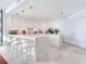 Modern, all-white kitchen featuring marble countertops, an island with seating, and plenty of cabinet space at 2912 W Santiago St # 1504, Tampa, FL 33629
