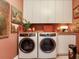 Well-organized laundry room with side-by-side washer and dryer, ample counter space, and overhead cabinets at 2912 W Santiago St # 1504, Tampa, FL 33629