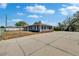 Exterior shot of a single story home with an ample yard, large driveway, and a carport at 3012 Bonita Dr, Plant City, FL 33566
