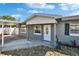 View of the front of a home with a covered carport, white trim, and landscaping at 3012 Bonita Dr, Plant City, FL 33566