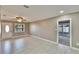 Bright living room featuring new tile floors, ceiling fan, and large window for natural light at 3012 Bonita Dr, Plant City, FL 33566