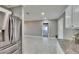 View of the open concept living room adjacent to the kitchen with light grey tile flooring and a stainless refrigerator at 3012 Bonita Dr, Plant City, FL 33566