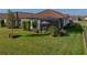 Home backyard featuring a screened patio, lush lawn and mature landscaping at 3106 Francoa Dr, Odessa, FL 33556