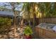 Landscaped backyard featuring a hot tub, patio, and storage shed at 3116 W Wallcraft, Tampa, FL 33611