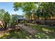 A landscaped backyard featuring garden beds, artificial turf and privacy fence at 3116 W Wallcraft, Tampa, FL 33611