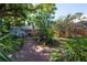Landscaped backyard with garden beds and shed at 3116 W Wallcraft, Tampa, FL 33611