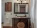 A well-lit bathroom features a dark wood vanity and an antique style mirror above the sink at 3116 W Wallcraft, Tampa, FL 33611