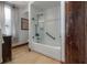 Bright bathroom featuring subway tile surround and shower/tub combination with glass partition at 3116 W Wallcraft, Tampa, FL 33611