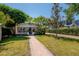 Inviting bungalow with a brick pathway, well-maintained lawn, and mature trees at 3116 W Wallcraft, Tampa, FL 33611