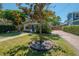 Landscaped front yard featuring a mature tree and brick-paved driveway at 3116 W Wallcraft, Tampa, FL 33611