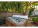 Backyard hot tub with a towel on top, in a shady area with an established tree at 3116 W Wallcraft, Tampa, FL 33611