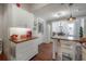 An open kitchen and dining area with wood floors and white cabinets at 3116 W Wallcraft, Tampa, FL 33611