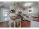 Kitchen showcasing white cabinets, butcher block island with seating, and modern fixtures at 3116 W Wallcraft, Tampa, FL 33611
