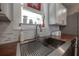 Stainless steel farmhouse kitchen sink with window and subway tile backsplash at 3116 W Wallcraft, Tampa, FL 33611