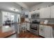 Stainless steel appliances and countertops in this updated kitchen, open to dining room at 3116 W Wallcraft, Tampa, FL 33611
