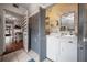 Well-equipped laundry area with side by side washer and dryer and storage shelves at 3116 W Wallcraft, Tampa, FL 33611